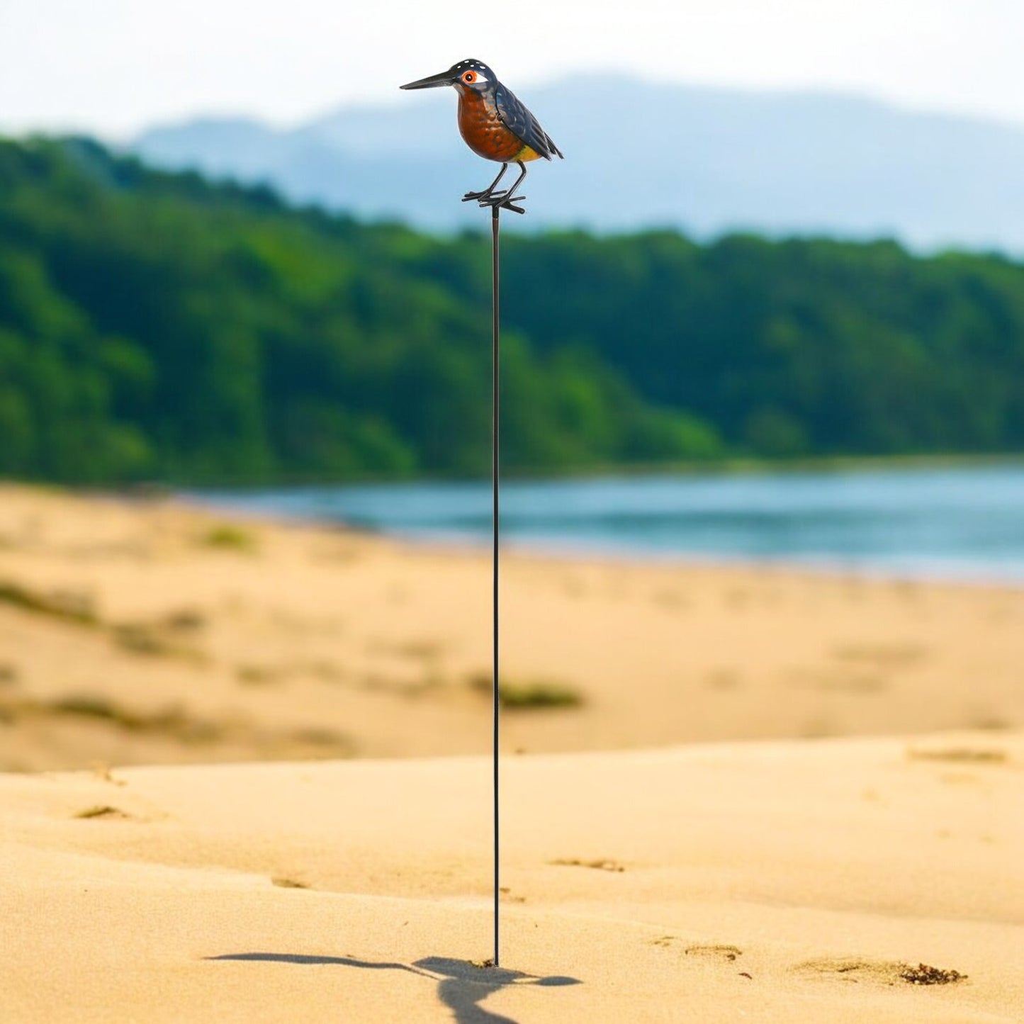 a bird standing on top of a metal pole