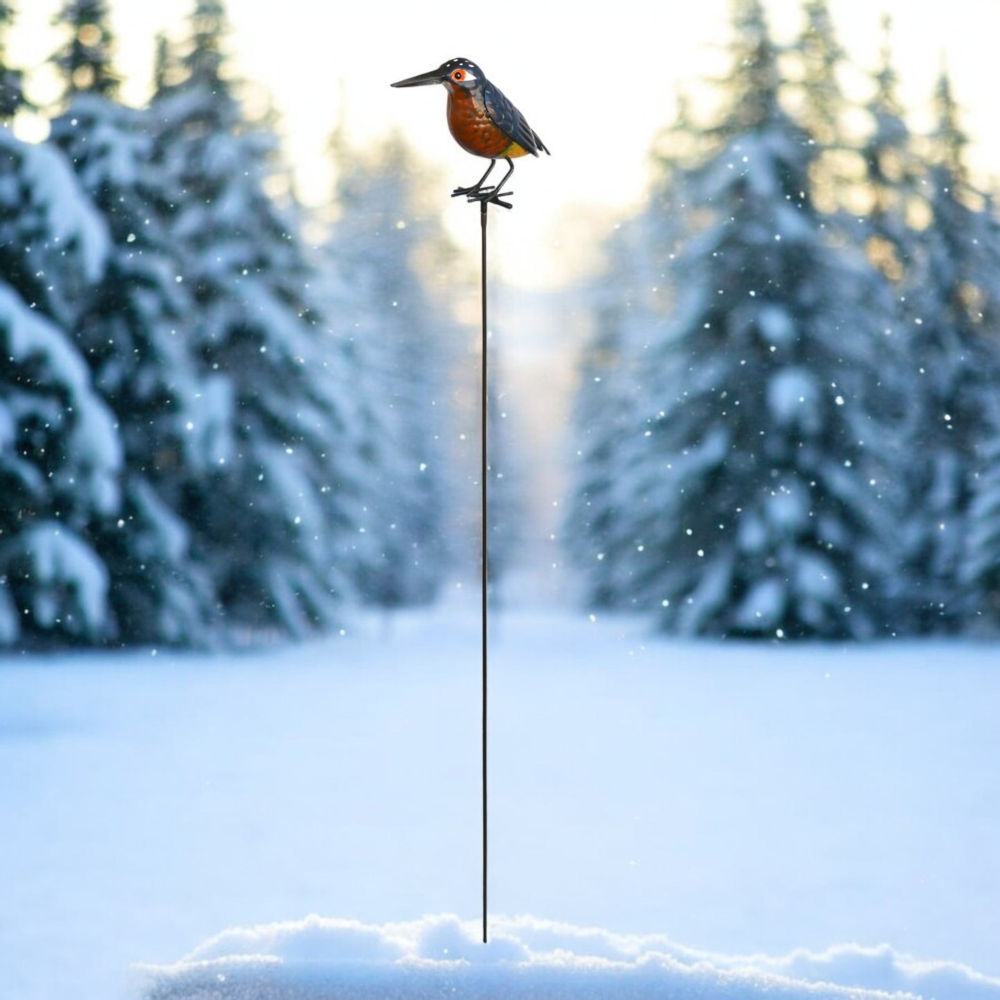 a bird sitting on top of a pole in the snow