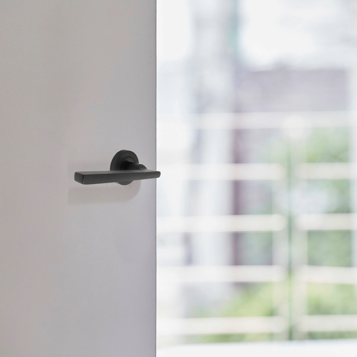 Matt Black Modern Lever on Round Rose Door Handles - 115mm handle with 52mm rose